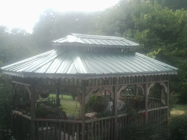 Two tier green metal roof on a garden gazebo in Virginia